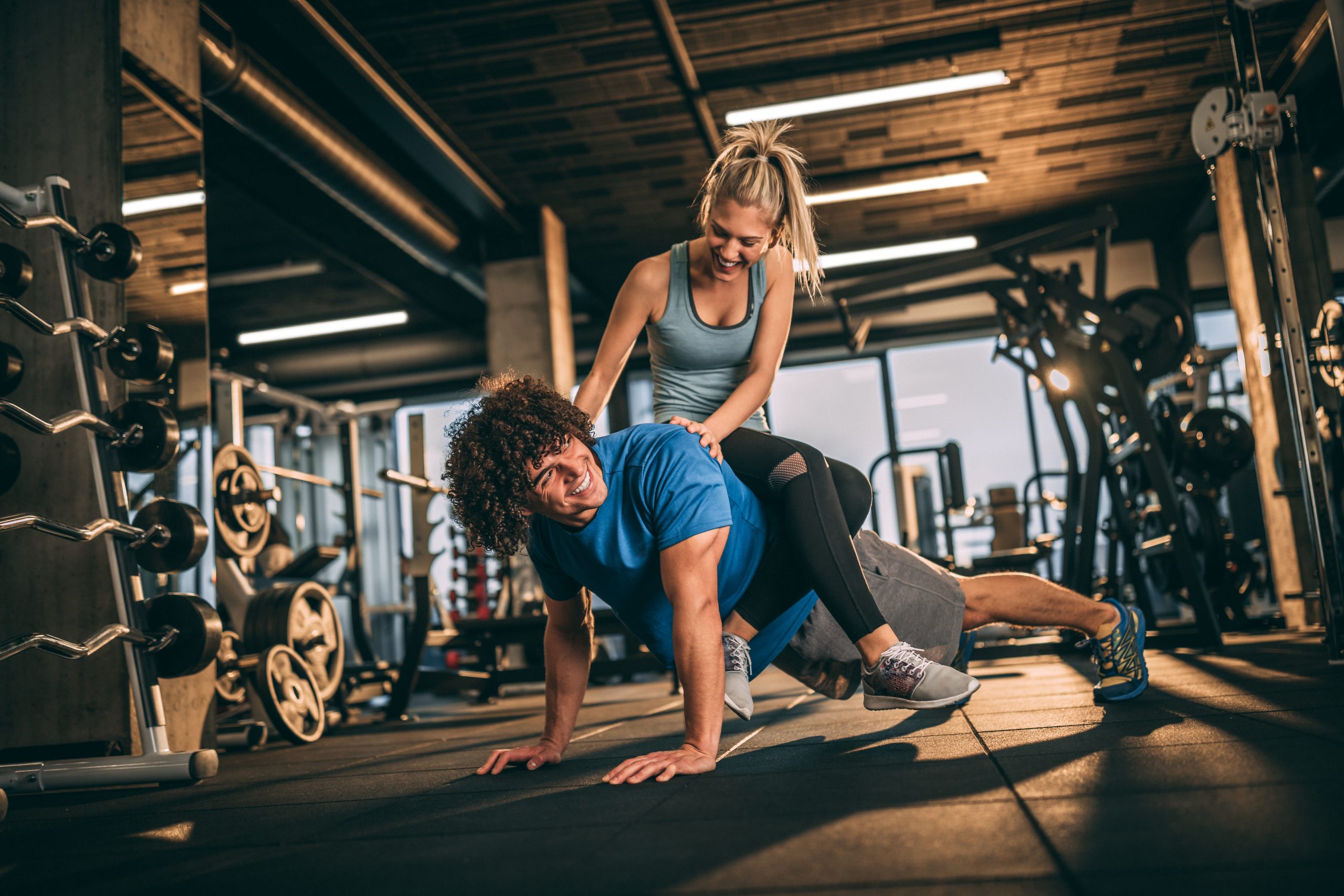 Young couple having fun in fitness center.